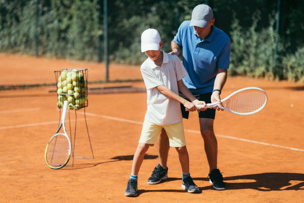 Boy Learning to Play Tennis