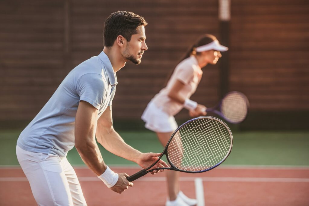 Couple playing tennis